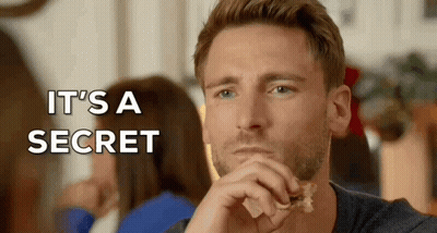 A Man Eating A Piece Of Food With The Words " It 'S A Secret " Written Above Him GIF