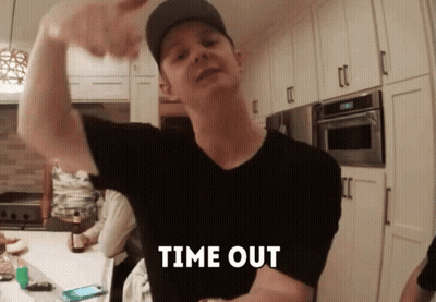 A Man Flexing His Muscles In A Kitchen With The Words Time Out Written On His Chest GIF