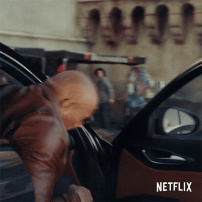 A Man Getting Out Of A Car With A Netflix Logo On The Bottom GIF