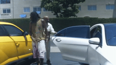 A Man Getting Out Of A White Car With A Yellow Car Behind Him GIF