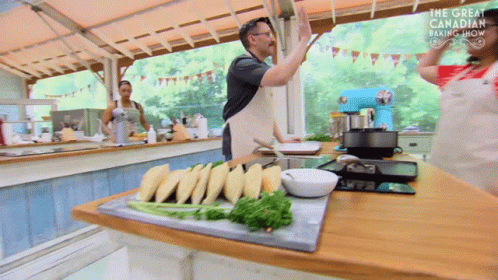 A Man Giving A High Five In A Kitchen With The Words The Great Canadian Baking Show On The Bottom GIF