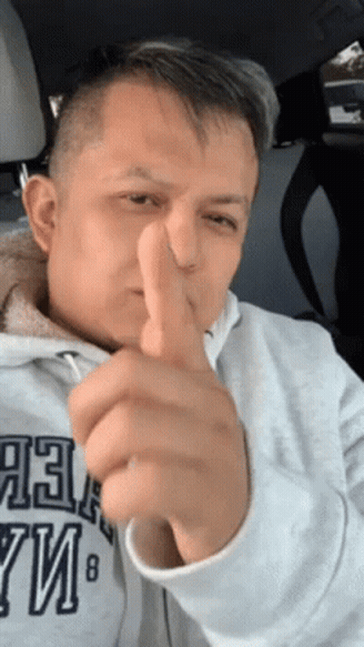 A Man Giving A Thumbs Up In A Car While Wearing A Sweatshirt That Says Abercrombie & Fitch GIF