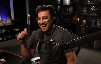 A Man Giving A Thumbs Up In Front Of A Microphone With The Words " Two Thumbs Up " Below Him GIF