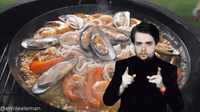 A Man Giving A Thumbs Up In Front Of A Pan Of Seafood And Rice GIF