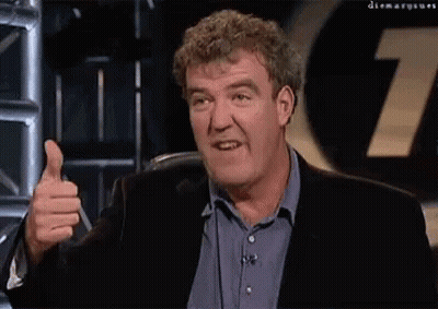 A Man Giving A Thumbs Up In Front Of A Sign That Says 7 GIF