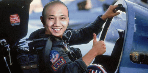 A Man Giving A Thumbs Up In Front Of A Sign That Says Danger Do Not Pull Handles GIF