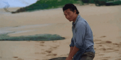 A Man Giving A Thumbs Up On A Beach GIF