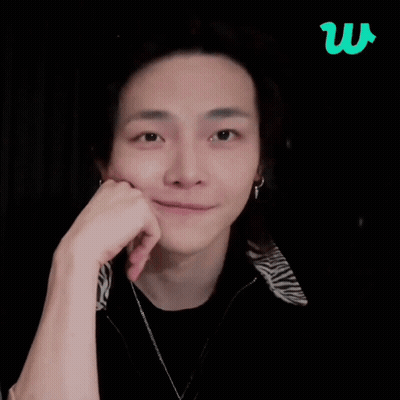 A Man Giving A Thumbs Up With A Green Letter W In The Background GIF