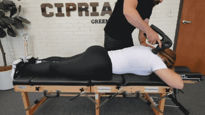 A Man Giving A Woman A Massage In Front Of A Sign That Says Cipria GIF