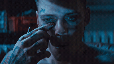 A Man Has A Tattoo On His Face That Says ' A ' On It GIF