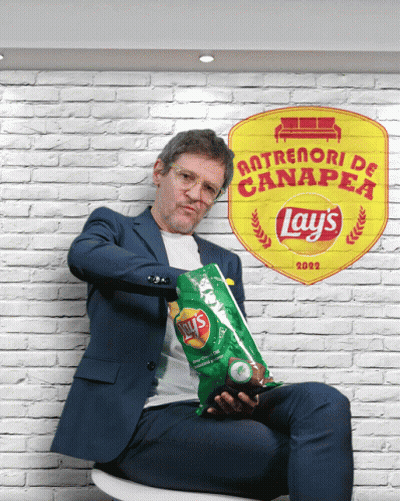 A Man Holding A Bag Of Lays Chips In Front Of A Brick Wall GIF