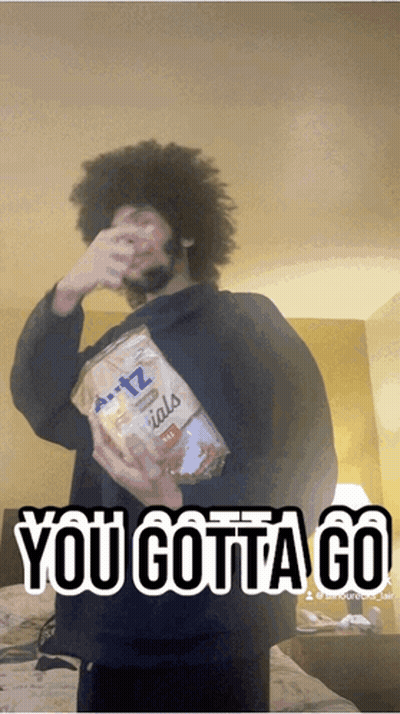 A Man Holding A Bag Of Pretzels With The Words " You Gotta Go " Above Him GIF