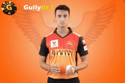 A Man Holding A Ball In Front Of Gullybet GIF