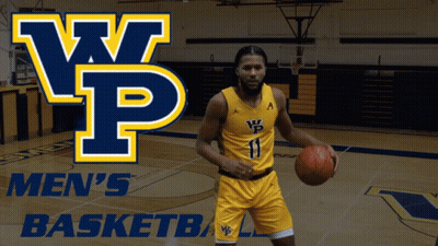 A Man Holding A Basketball In Front Of A Sign That Says Men 'S Basketball GIF