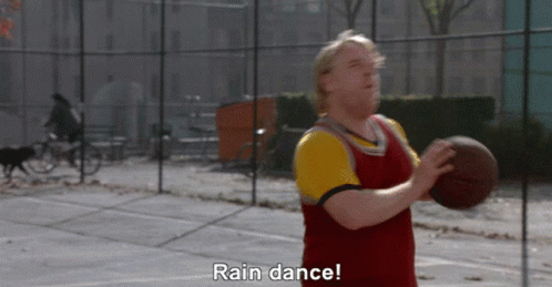 A Man Holding A Basketball On A Court With The Words Rain Dance Above Him GIF