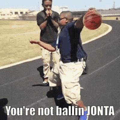 A Man Holding A Basketball On A Track With The Words You 'Re Not Ballin Jota On The Bottom GIF