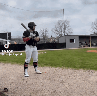 A Man Holding A Bat On A Baseball Field With A Tiktok Logo On The Bottom GIF