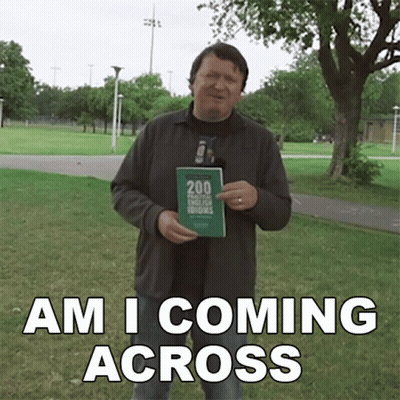 A Man Holding A Book With The Words Am I Coming Across GIF