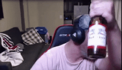 A Man Holding A Bottle Of Budweiser In Front Of His Face . GIF