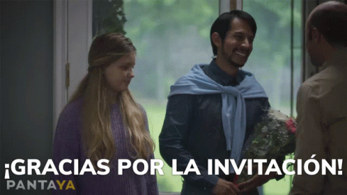A Man Holding A Bouquet Of Flowers Stands Next To A Woman And Says Gracias Por La Invitacion On The Bottom GIF