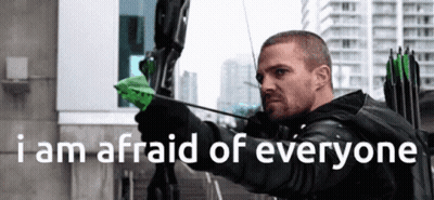 A Man Holding A Bow And Arrow With The Words " I Am Afraid Of Everyone " Below Him GIF