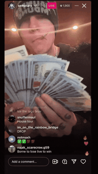 A Man Holding A Bunch Of Money In Front Of A Screen That Says Sematary GIF