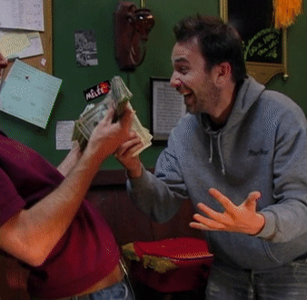 A Man Holding A Bunch Of Money With A Sticker That Says Mette GIF
