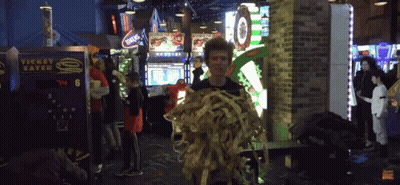 A Man Holding A Bunch Of Spaghetti In Front Of A Machine That Says Ticket Eater GIF