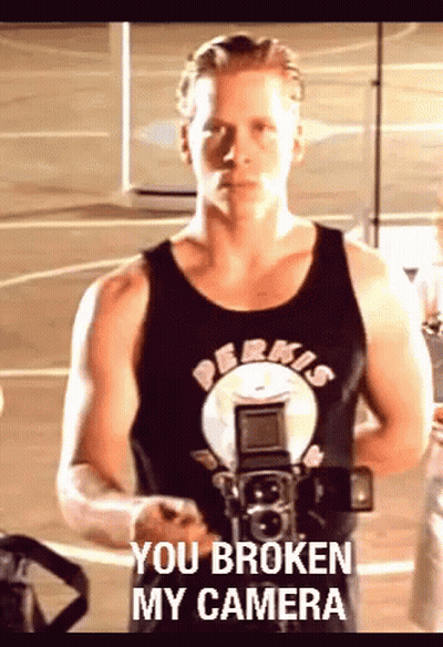 A Man Holding A Camera With The Words You Broken My Camera Written On The Bottom GIF