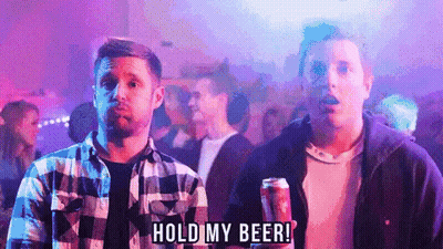 A Man Holding A Can Of Beer With The Words Hold My Beer Below Him GIF