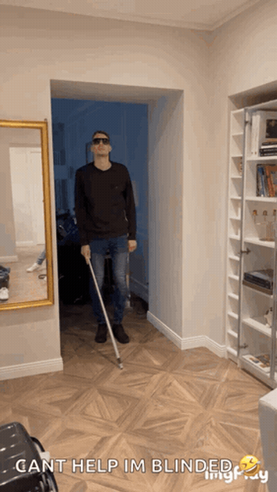 A Man Holding A Cane In A Hallway With The Words Cant Help Im Blinded GIF