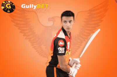 A Man Holding A Cricket Bat In Front Of A Gully Bet Logo GIF