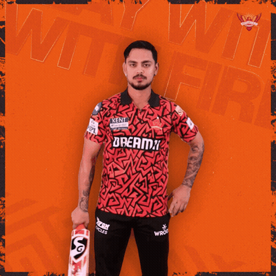 A Man Holding A Cricket Bat With The Word Dreamz On His Shirt GIF