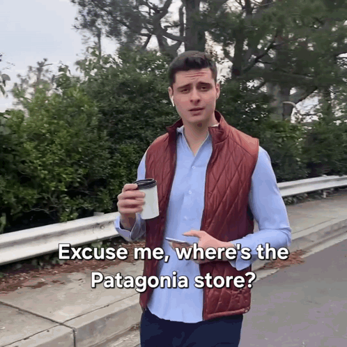 A Man Holding A Cup Of Coffee Is Asking Where The Patagonia Store Is GIF