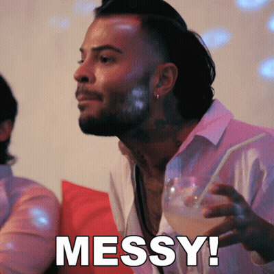 A Man Holding A Drink With The Word Messy Written On The Bottom GIF