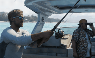 A Man Holding A Fishing Rod On A Boat While Another Man Looks Through Binoculars GIF