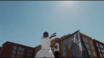 A Man Holding A Flag That Says Pglang GIF