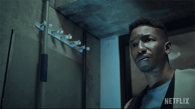 A Man Holding A Flashlight With A Netflix Logo In The Background GIF