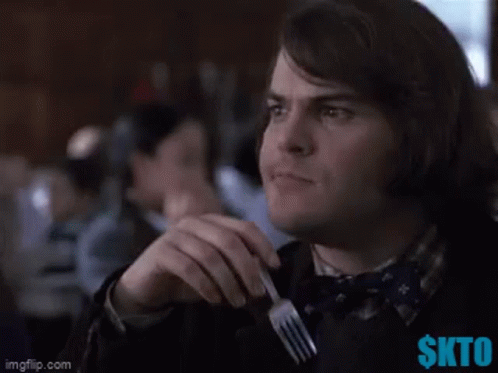 A Man Holding A Fork With The Words Hmm Written Above Him GIF