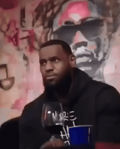 A Man Holding A Glass Of Wine With The Word More On It GIF