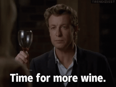 A Man Holding A Glass Of Wine With The Words Time For More Wine Below Him GIF