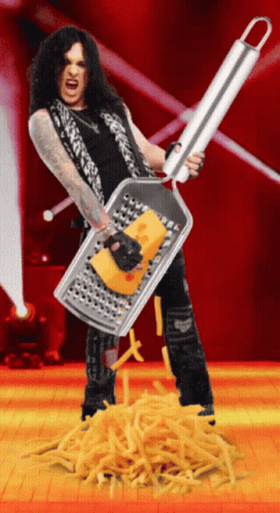 A Man Holding A Grater With A Piece Of Cheese In It GIF