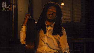 A Man Holding A Guitar With The Words All My Life Below Him GIF