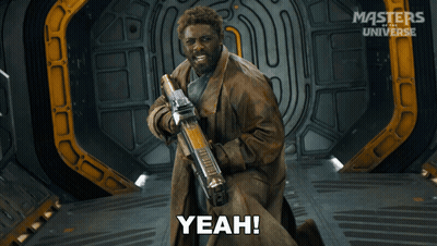 A Man Holding A Gun And Saying Yeah In Front Of Masters Of The Universe GIF