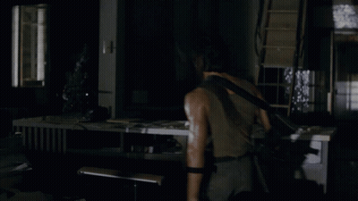 A Man Holding A Gun In A Dark Room With The Words Nothing Is Over Below Him GIF