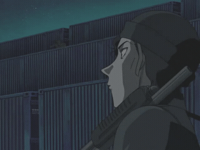 A Man Holding A Gun In Front Of A Building At Night GIF