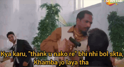 A Man Holding A Gun Says " Thank U Nako Re " While Another Man Watches GIF