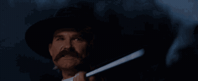 A Man Holding A Gun With The Words " Hell 'S Coming With Me " Behind Him GIF