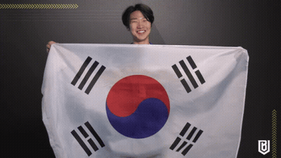 A Man Holding A Korean Flag With The Letter B On It GIF