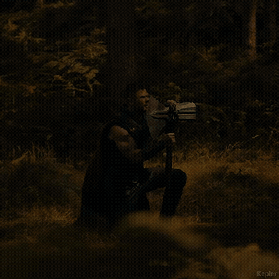 A Man Holding A Large Axe In A Forest With The Name Kepler Visible In The Corner GIF
